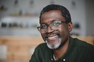 man smiling after all-on-4 dental implants from Clayton Dental Group helped restore his smile