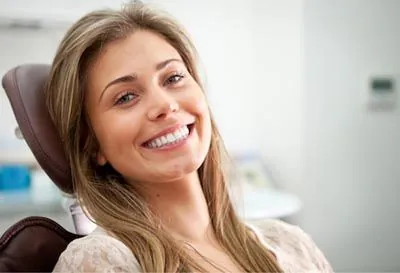 patient showing off her new smile after crown lengthening