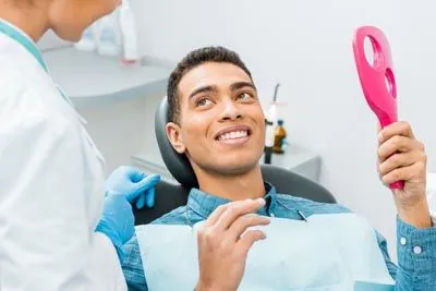patient talking with Dr. Haidari about his new dental veneers